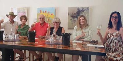 Six people enjoying winetasting